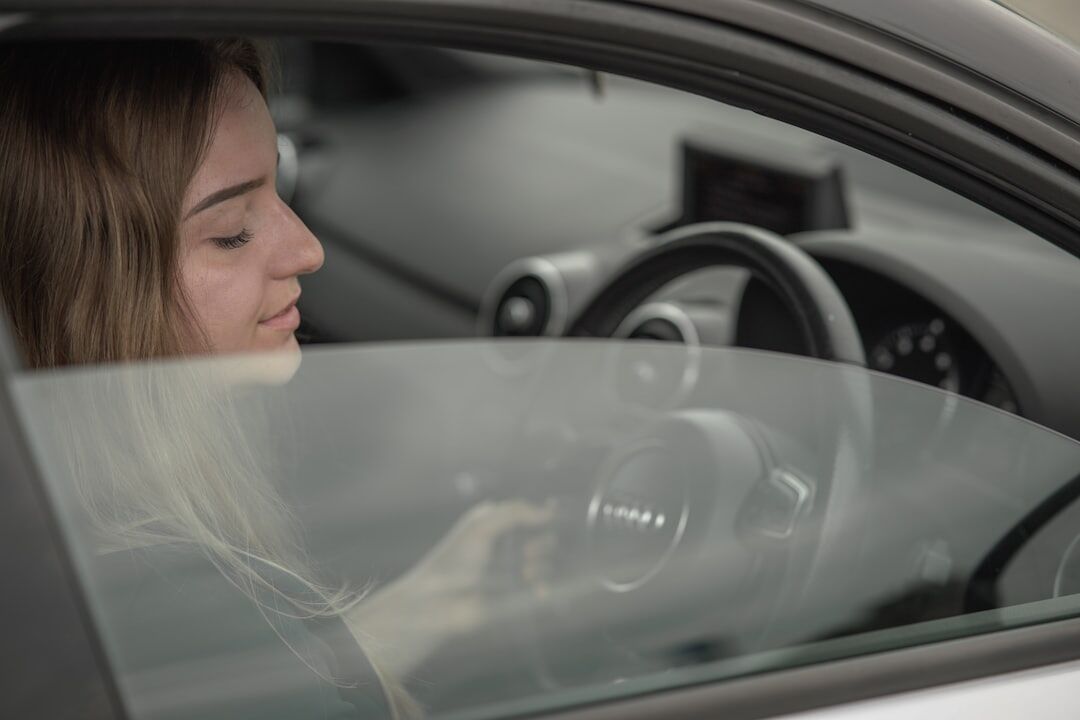 Young woman learning to drive a car